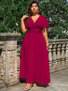 Detail of wine red V-neck maxi dress with ruffled sleeves and elastic waist in outdoor setting
