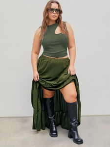 Detail of olive green asymmetric cutout knit vest and matching long satin skirt outfit