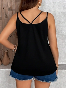 Women's black slim fit tank top featuring elegant crisscross back straps and smooth fabric