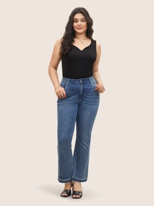 Chic black V-neck tank top and high-waisted flare jeans outfit for women in casual style