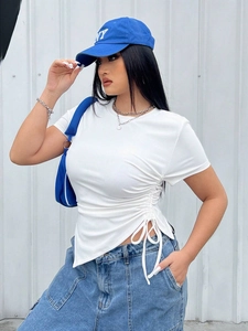 Close-up of side drawstring ruching and asymmetric hem on white ribbed t-shirt