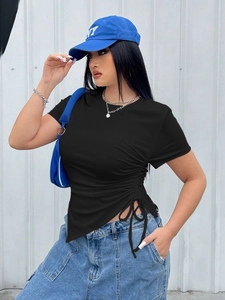 Detail view of black slim-fit T-shirt with drawstring waist and asymmetrical hem