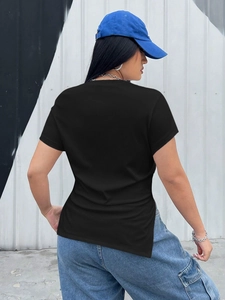Detail of black ribbed t-shirt showing the irregular side slit and fitted back silhouette