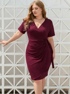 Detail of elegant burgundy plus size wrap dress with V-neck and ruched waist design