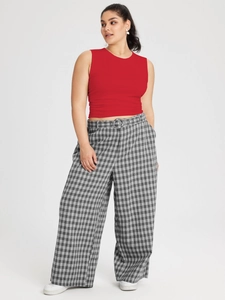 Women's plus size casual red sleeveless tank top paired with black and white plaid wide leg pants