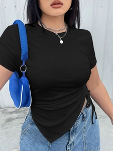 Detail of black ribbed knit t-shirt featuring side drawstring and ruched asymmetric hem