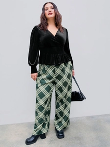 Elegant V-neck velvet top with ruffled hem paired with plaid wide-leg pants street style