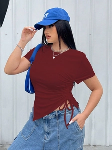 Detail of burgundy ribbed T-shirt showing side drawstring and asymmetric hem design