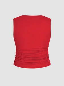 Close-up of red sleeveless tank top featuring elegant back ruching and pleated details