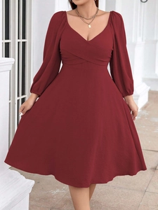 Detail of elegant V-neck wine red dress with pleated crossover and lantern sleeves