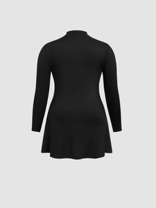 Detail view of black long sleeve A-line mini dress with ribbed texture and high collar back