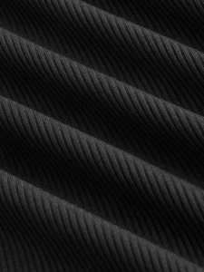 Macro shot of black ribbed knit fabric showing fine texture and vertical weave detail