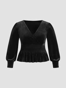 Elegant black velvet V-neck long sleeve top with smocked waist and peplum hem