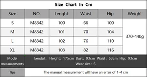 Detailed size chart for knitted wide-leg trousers showing measurements from S to XL