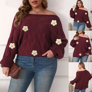 Close-up of chunky knit burgundy off-shoulder sweater with 3D white daisy floral details
