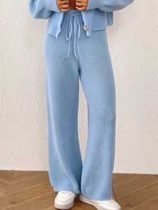 Detail of light blue knitted set featuring ribbed texture and drawstring waistband