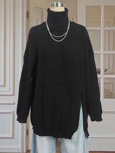 Women's black oversized turtleneck knit sweater with side split and ribbed texture