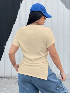 Detail of knit ribbed short sleeve top featuring an asymmetric hem and side slit design