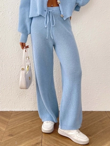 Detail of light blue knit set showing drawstring waistband and ribbed vertical texture
