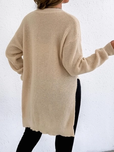 Women's long beige knit sweater featuring a stylish side slit and ribbed cuffs back view