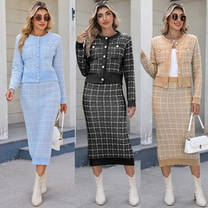 Detail of plaid knit cardigan and skirt set featuring elegant pearl button accents