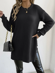 Detail view of black ribbed knit sweater dress with round neck and side slit style