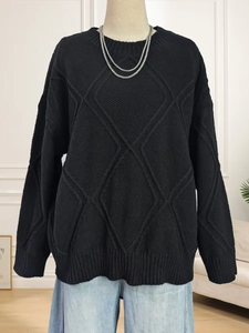 Women's black diamond lattice knit sweater with a relaxed crewneck and long sleeves