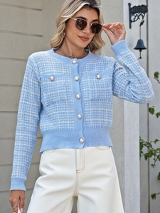 Close-up of light blue plaid cardigan featuring textured knit and elegant pearl buttons
