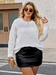 Detail shot of the white diamond pattern knit sweater showing soft texture and cozy fit