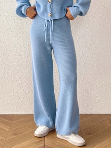 Detail of light blue knitted set showing textured fabric and drawstring waist wide-leg pants