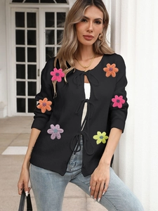 Women's black knit cardigan with colorful 3D crochet flowers and front tie-up ribbons