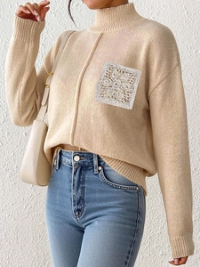 Beige mock neck knit sweater featuring a sequined lace pocket and ribbed cuffs