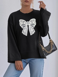 Women's black knit sweater with white lace bow pattern and casual crew neck long sleeves