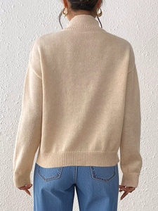Elegant beige turtleneck sweater for women with long sleeves and ribbed knit details