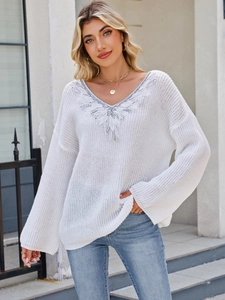 Loose white V-neck knit sweater with silver sequin embroidery and lace leaf details