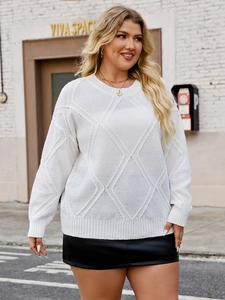 Detailed view of women's beige knit sweater with diamond pattern and textured fabric