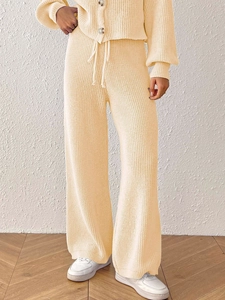 Women's apricot knit two-piece set featuring buttoned cardigan and wide-leg trousers