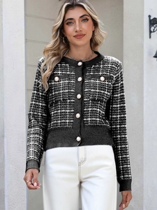 Detail of classic black and white plaid cardigan featuring elegant large pearl buttons