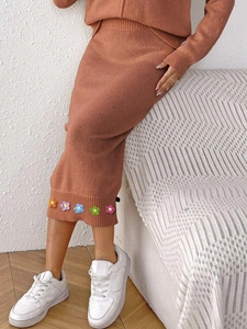 Two-piece knit set in tan with long sleeve crop top and floral crochet pencil skirt