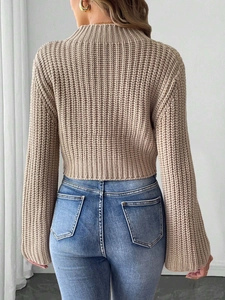 Close-up of beige ribbed knit cropped sweater with elegant flare sleeves and back view detail