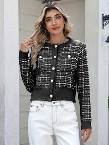 Close-up of elegant plaid knit cardigan featuring pearl buttons and chic pocket details