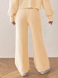Back view of cream knit loungewear set featuring wide-leg pants and cozy textured fabric