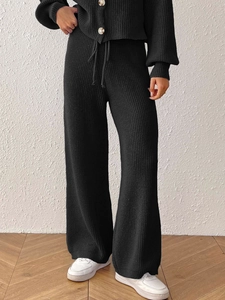 Women's black knit set featuring a buttoned cardigan and drawstring wide leg pants