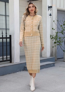 Detail of ginger yellow plaid knit set with pearl buttons and elegant textured fabric