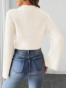 Women's white cropped knit sweater featuring flared sleeves and a mock neck silhouette