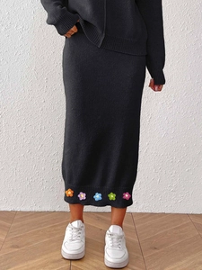 Women's black knit midi bodycon skirt with colorful 3D crochet floral embellishments