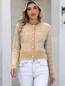 Close-up of elegant yellow plaid knit cardigan featuring large luxury pearl buttons