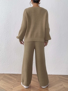 Detail of khaki knitted set showing the vertical ribbed texture and high-quality drape