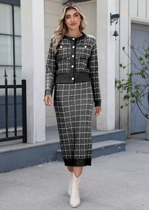 Outdoor street view of a black and white plaid knit cardigan and pencil skirt set