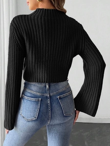 Rear view of cropped black knit sweater with flare sleeves and high neck design